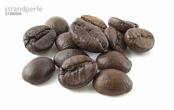 Roasted coffee beans close up isolated on white background