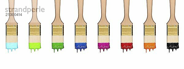 Colourful dropping set of paint brushes in a row isolated on white background