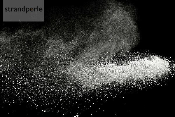 Bizarre forms of white powder explosion cloud against black background.White dust particles splash