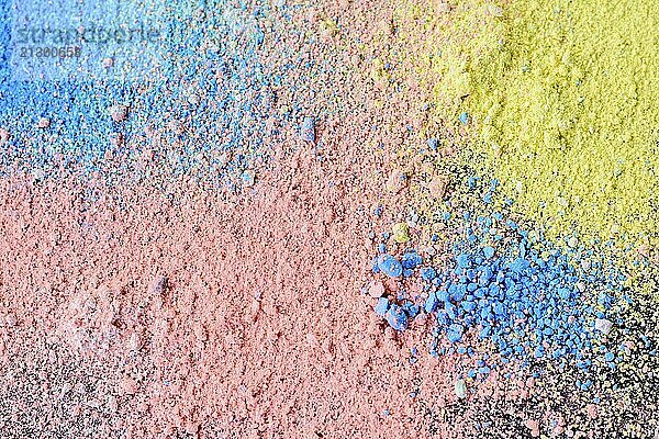 Colorful background of chalk powder. Multicolored dust particles splattered on black background