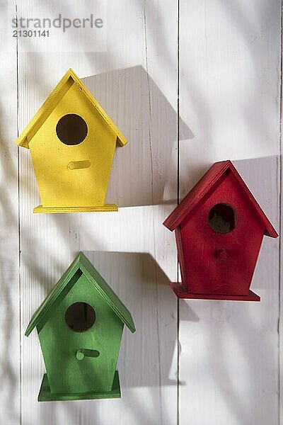 Small colorful houses for shelter birds hung on a wall