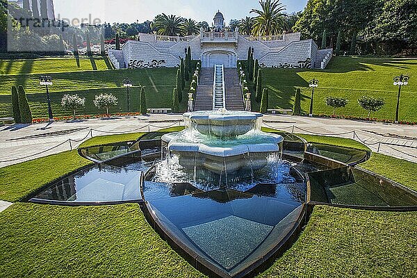 Idyllic sunny view on beautiful fountain in the shape of a Star of David  Terraced Bahá'í Garden (Shrine of the Bab) . Sunny day in winter in tropical Israel