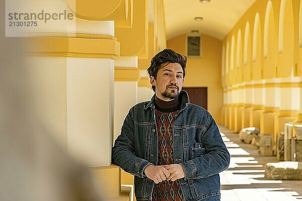 Portrait of a stylish handsome young man with a jaket outdoors. A serious man wearing a jaket looking confident at the camera