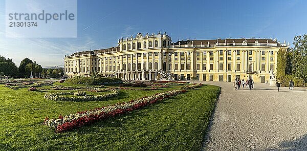 Vienna  Austria  22 September  2022: view of the rear of the Schonbrunn Palace with colorful flowers in the gardens in warm evening light  Europe