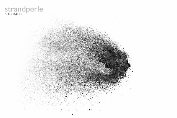 Black powder explosion on white background.Black dust particles splash