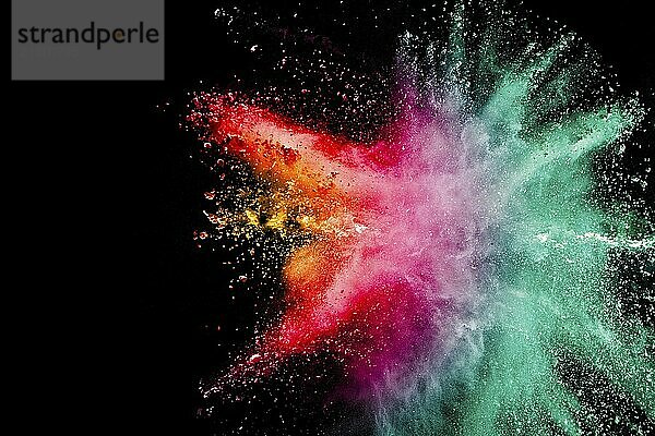 Abstract multicolored powder explosion on black background. Color dust particle splattered on background