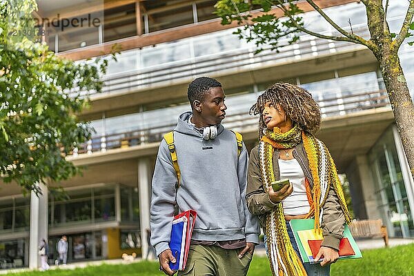 Multiethnic students walking out the university campus in a sunny day of autumn