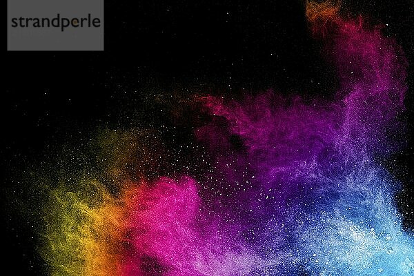 Colorful background of pastel powder explosion.Rainbow color dust splash on black background