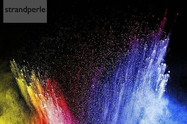 Abstract multi color powder explosion on black background. Freeze motion of colorful dust particles splash. Painted Holi