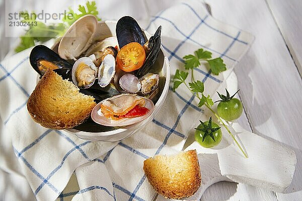 Presentation of a soup with seafood on white background