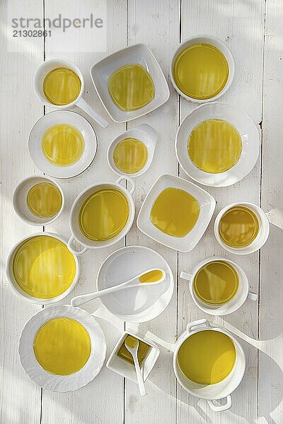 Presentation of small containers of extra virgin olive oil in white background