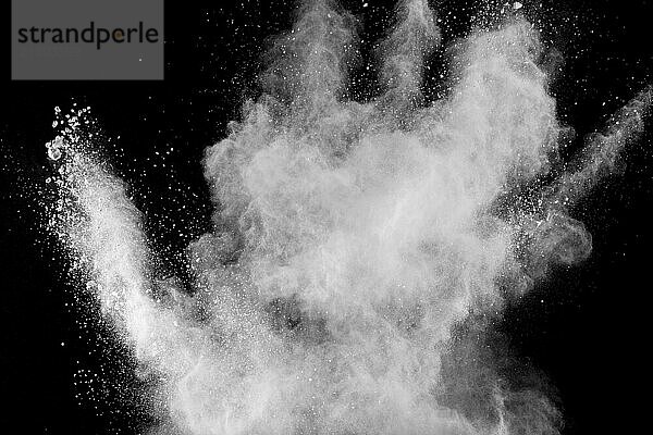 Bizarre forms of white powder explosion cloud against black background.White dust particles splash