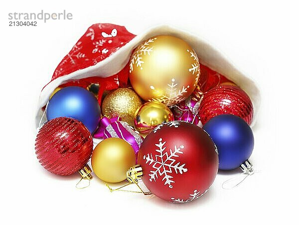 Bright christmas balls  toys in the red hat of Santa Claus on white background