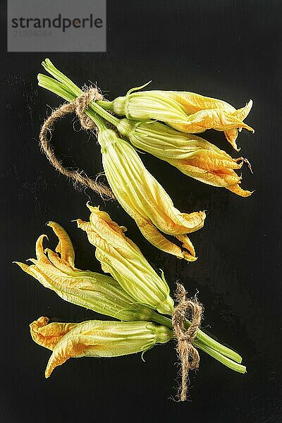 Presentation of yellow pumpkin flower on black background