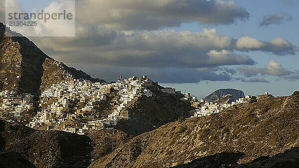 An expansive village view in the mountains under a dramatic cloudy sky  Colourful mountain village  Morning light  Olymbos  Karpathos  Dodecanese  Greek Islands  Greece  Europe