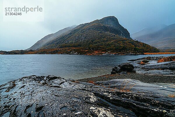 Scenic view of lake against mountian in Killarney National Park a misty day in the Ring of Kerry in Ireland