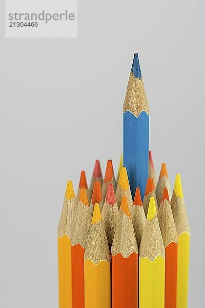 Abstract composition of a set wooden colour pencils against a white background