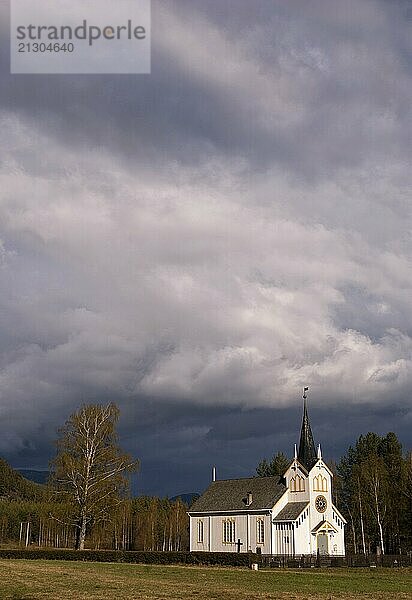 The church in the Norwegian village Vradal in front of approaching bad weather