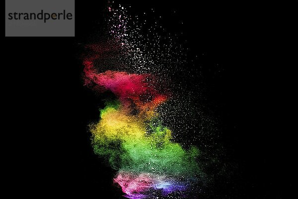 Explosion of colorful Holi powder on black background. Vibrant color dust particles textured background