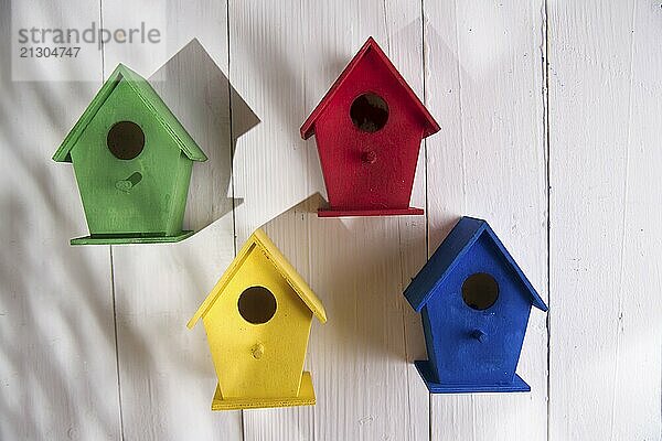 Small colorful houses for shelter birds hung on a wall