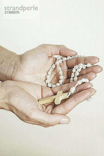 Hands with Rosary on white background