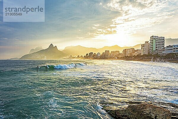 Sunset on Ipanema beach in the city of Rio de Janeiro with the mountains in the background