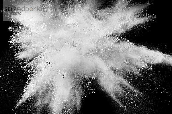 Bizarre forms of white powder explosion cloud against black background.White dust splash