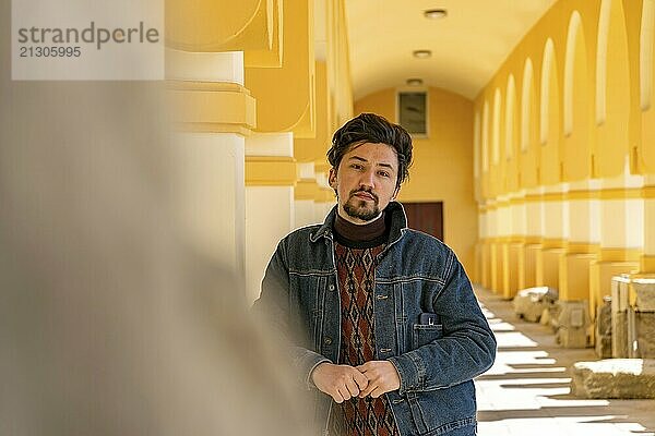 Portrait of a stylish handsome young man with a jaket outdoors. A serious man wearing a jaket looking confident at the camera