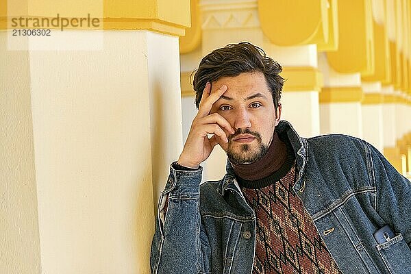 Portrait of a stylish handsome young man with a jaket outdoors. A serious man wearing a jaket looking confident at the camera