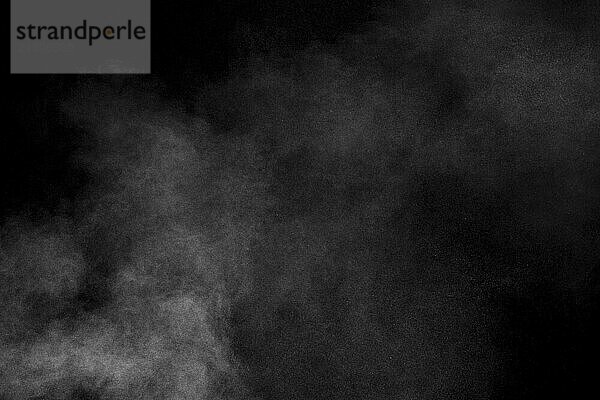 White dust cloud in the air.Abstract white powder explosion against black background