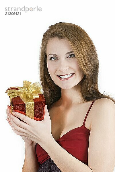 Happy teenage girl with gift box over white background