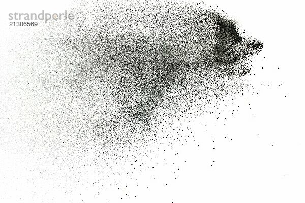 Black powder explosion on white background.Black dust particles splash