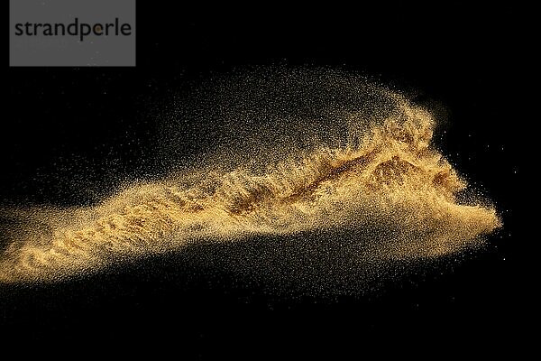 Dry river sand explosion.Brown color sand splash against black background