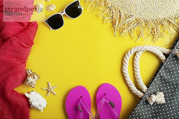 Straw hat sunglesses flip flops beach bag on yellow background vacation travel planning mockup