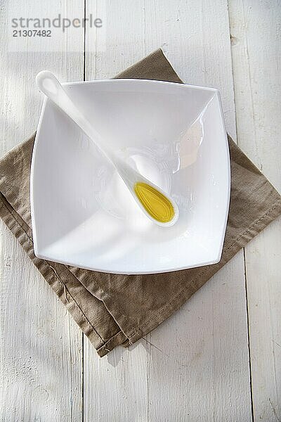 Presentation of small containers of extra virgin olive oil in white background