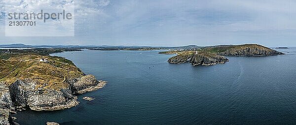 A panorama view of the entrance to the Baltimore Harbor in West Cork with teh Sherkin Island Lighthouse and the Baltimore Beacon