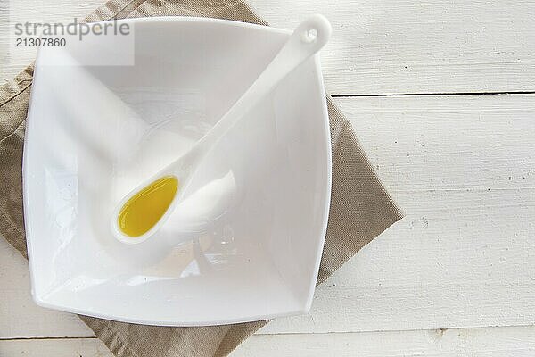 Presentation of small containers of extra virgin olive oil in white background