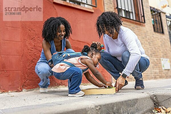 African three generation woman family playing with toys in the city with baby girl