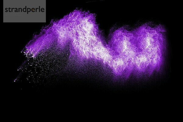 Purple color powder explosion on black background