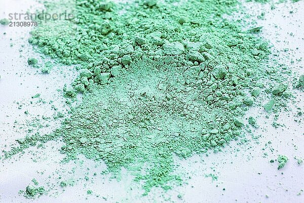 Green color background of chalk powder. Green color dust particles splattered on white background