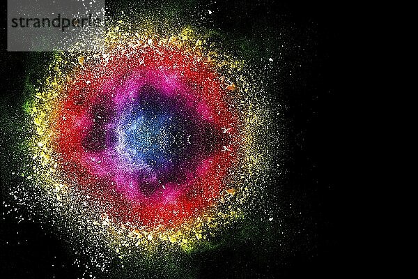 Color powder explosion cloud on black background. Freeze motion of color dust particles splashing