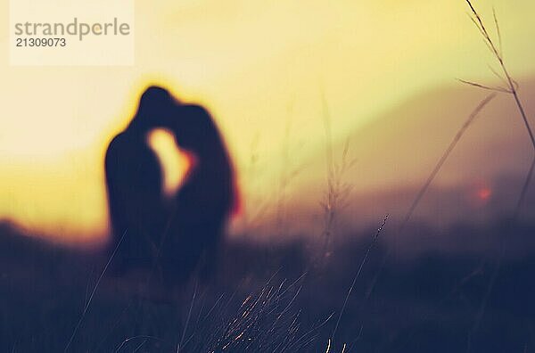 Retro Filtered Image Of A Romantic Couple Embracing Fitness At Sunset