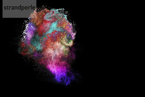 Multicolored powder explosion on black background