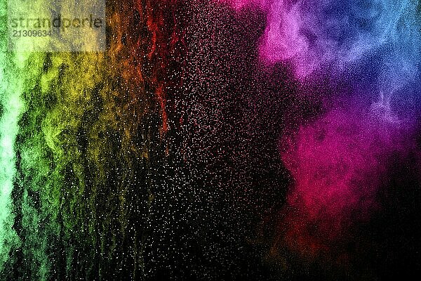 Abstract multicolored powder explosion on black background. Color dust particle splattered on background