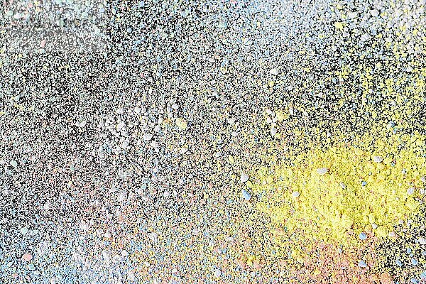 Colorful background of chalk powder. Multicolored dust particles splattered on black background