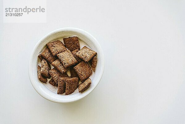 Cereals with yogurt isolated on white table. Horizontal composition  top view  space for copy