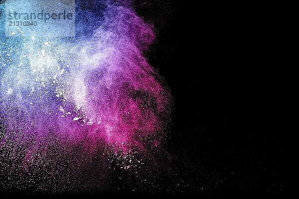 Abstract multi color powder explosion on black background. Freeze motion of colorful dust particles splash. Painted Holi