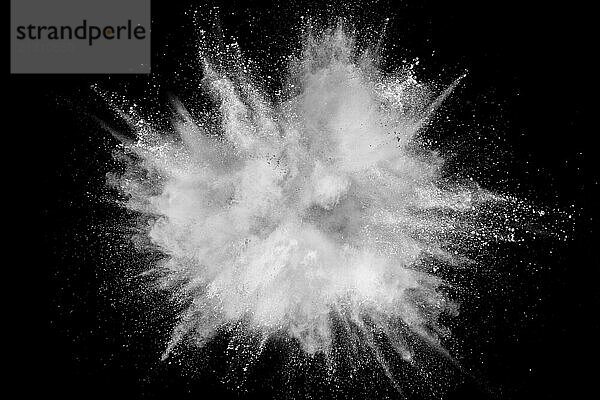 White powder explosion isolated on black background. White dust particles splash.Color Holi Festival