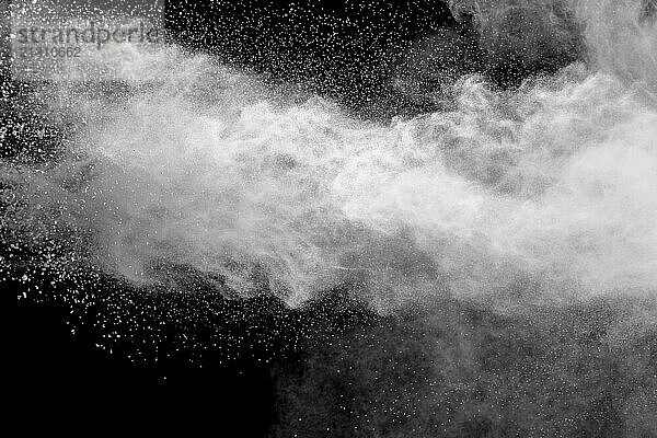 White talcum powder explosion on black background. White dust splashing