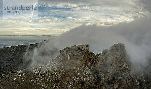 Magazzini  Italy  14 November  2023: drone view of the Castello del Volterraio shrouded in morning fog and cloud  Europe